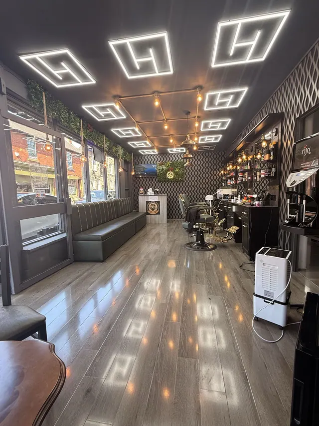 Inside Oxford Road Barber: the chairs, sofa and lit ceiling